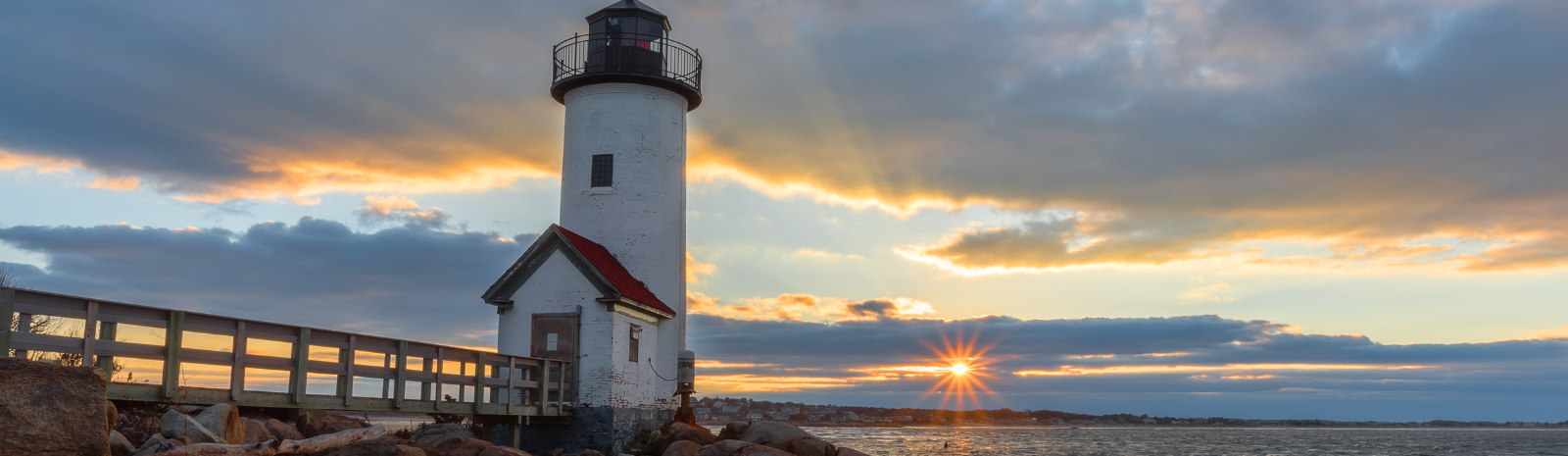 Annisquam Gloucester, scenic view of board walk to lighthouse with ocean view and sunset in the background.