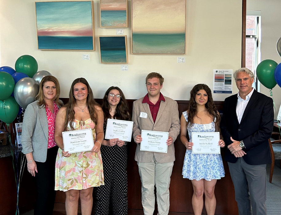 BankGloucester President Patrick Thorpe and Vice President Amy Mitchell presenting scholarship awards to group of 2026 graduates.