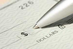 Close up of pen writing out a new check.